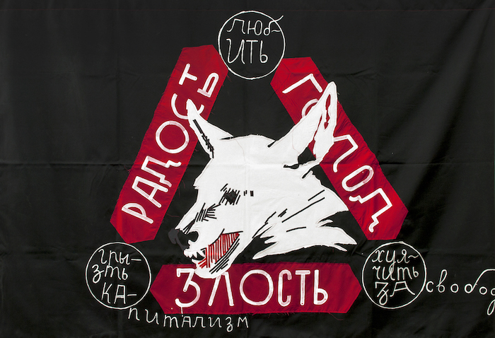 Revolution from Without, featuring Tania Bruguera, Tony Cokes, Chto Delat, Raqs Media Collective, Kameelah Janan Rasheed, Dread Scott, and Mark Wallinger., at The 8th Floor, NYC, is reviewed at Riot Material magazine.