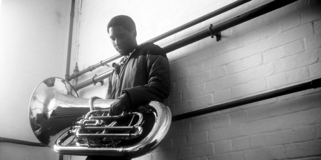 Theon Cross's new release, Fyah, is reviewed at Riot Material.