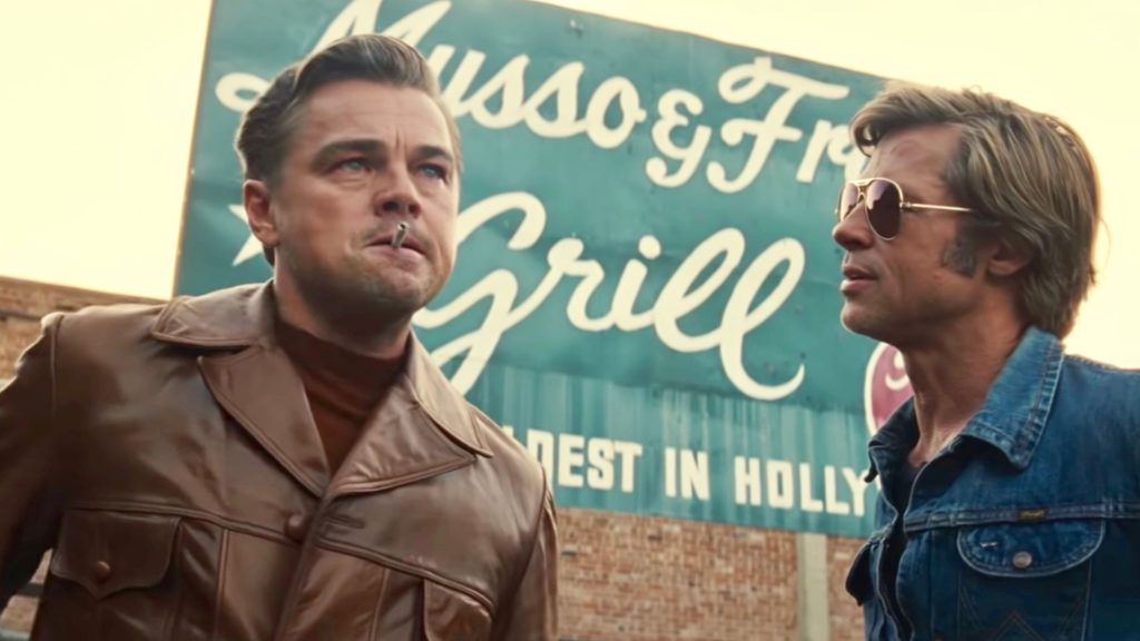 Leonardo DiCaprio and Brad Pitt in Once Upon A Time in Hollywood. A review of the film is at Riot Material, LA's premier magazine for art and film.